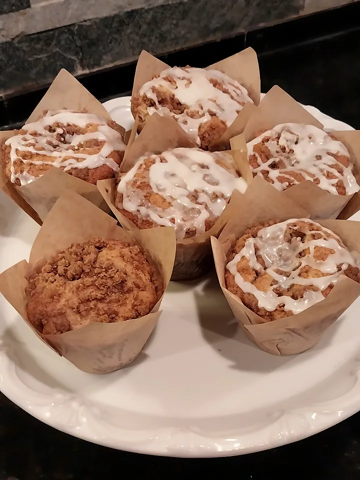 Cinnamon streusel muffins with a white glaze drizzle in kraft tulip cases, fresh from the Willow Bakery kitchen